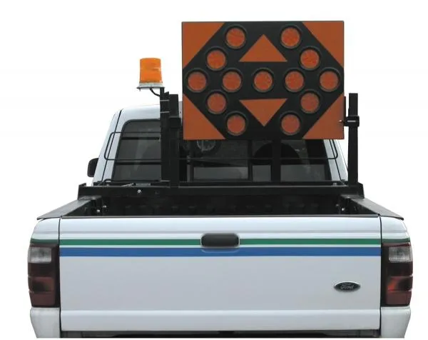 D&R AB253513 TC-12 arrowboard on a bed rack of a white pickup with an amber beacon beside it