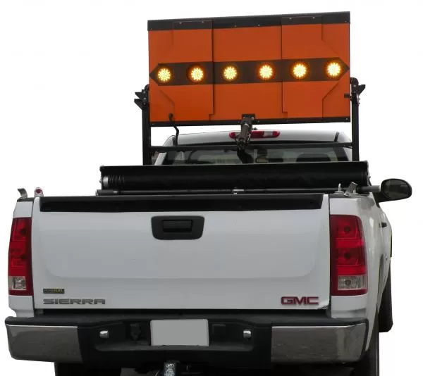 Rear view of the white GMC Sierra with the board raised and the centre lamp row illuminated