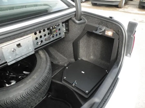 D&R 932-0014A trunk electronic mount door in a Dodge Charger beside the spare tire and equipment panel