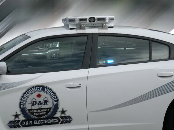 Optional MR6 linear LED lit blue in the rear window of a white Charger with D&R door decal