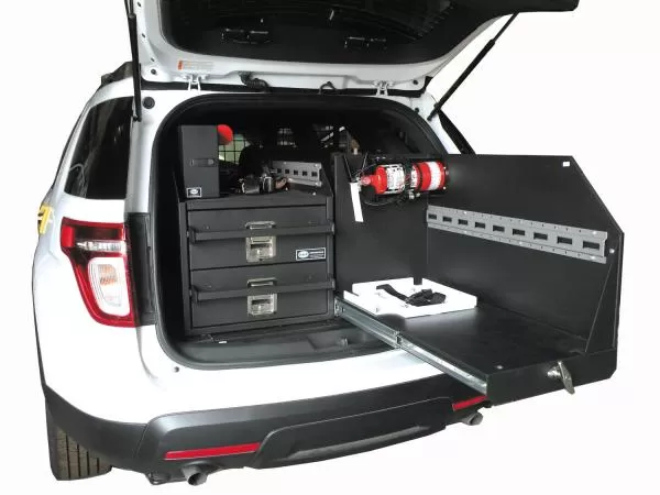 Slide-out tray extended past the rear bumper, slotted mounting panel and extinguisher alongside