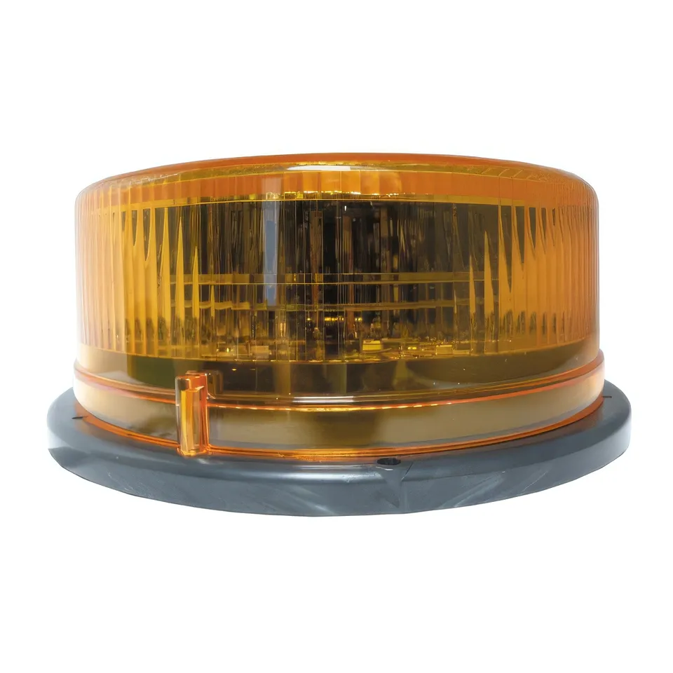 Amber-lens LED beacon seen from the side, shallow fluted dome on its moulded mounting base
