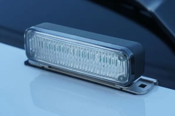 D&R Genesis LED light module deck mounted on a white cruiser hood, clear lens and stainless steel bracket