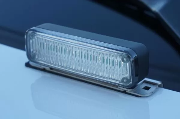 D&R Genesis LED light module deck mounted on a white cruiser hood, clear lens and stainless steel bracket