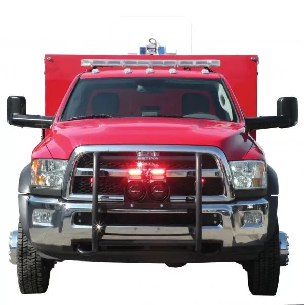 Red rescue truck head-on with grille lights flashing red, speakers on the push bumper and a roof lightbar