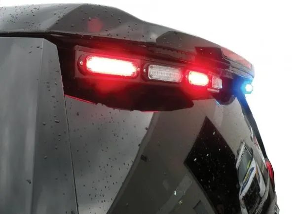 D&R GT2FTL-IC-TAH15 rear spoiler LED light stick flashing red on a rain-beaded Chevy Tahoe tailgate
