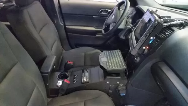 D&R CF33 docking station and screen on the dash of a police SUV, with centre console and keyboard tray