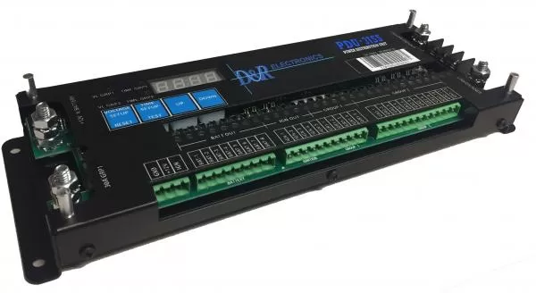 Power distribution unit with the cover off, showing setup buttons, fuse indicators and heavy battery and ground studs