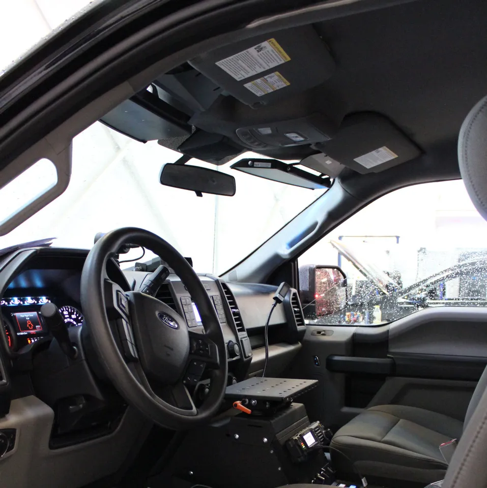 Ford F150 cab interior with the slim visor bar fitted along the windshield header beside the sun visors