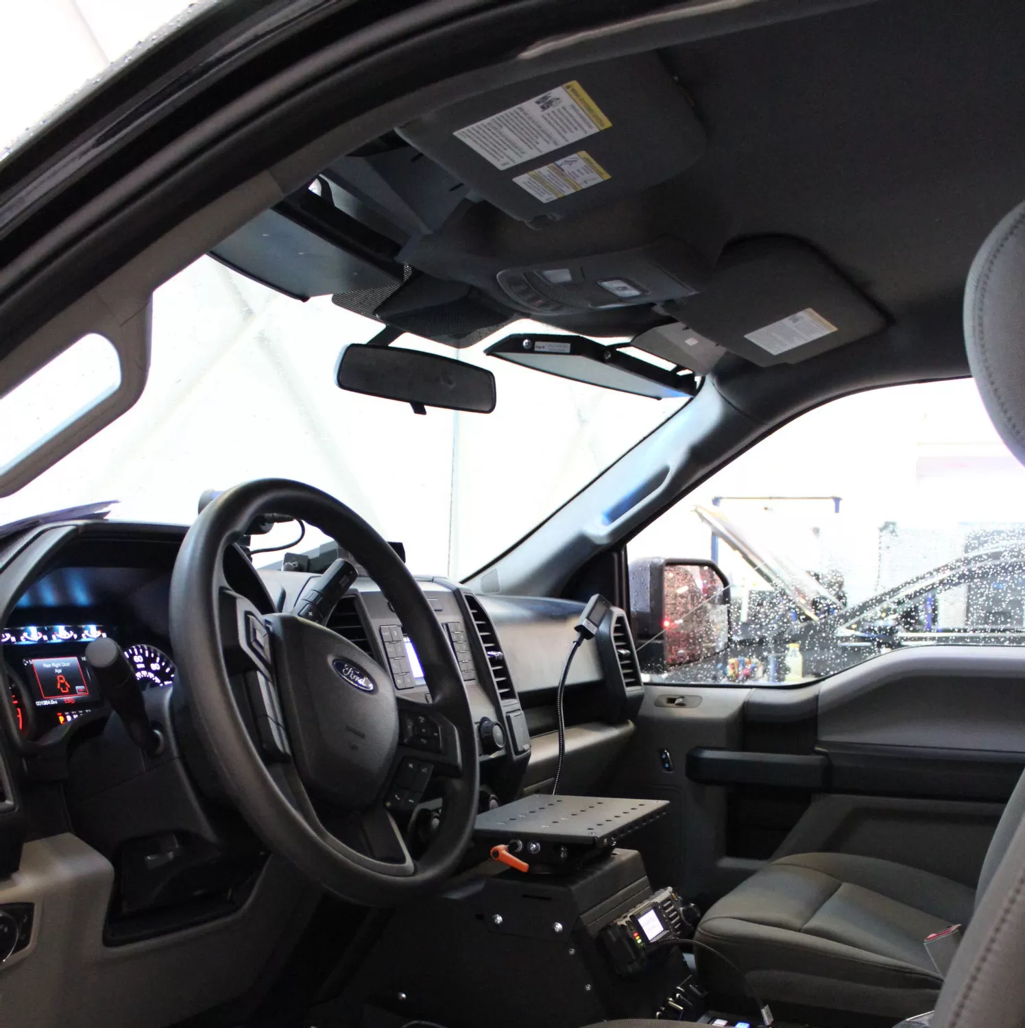 Ford F150 cab interior with the slim visor bar fitted along the windshield header beside the sun visors
