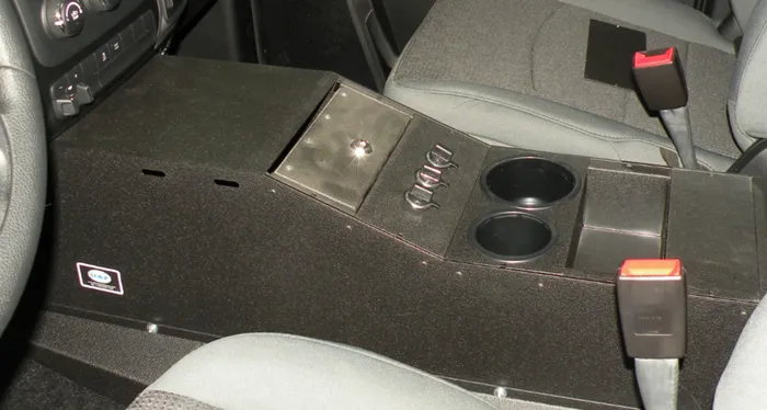D&R 901-0124A console for the Dodge Ram installed between the seats with hinged lid and dual cup holders