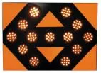 Close-up of the lit face, thirteen amber LED modules glowing against the orange reflective panel