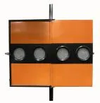 Opposite face of the arrowboard, four amber lamps set in a black band across the orange panels