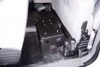 Unit bolted to the rear floor of a cruiser with a fuse strip and wiring connectors on the end panel
