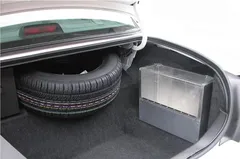 D&R SB04 aluminum storage box with plexi-glass latching cover mounted in a car trunk beside the spare tire