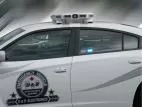 Optional MR6 linear LED lit blue in the rear window of a white Charger with D&R door decal