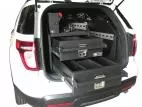 Both drawers pulled fully open at the tailgate of a white Ford utility, divided interiors visible