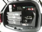 Angled shot of the closed drawer stack beside the equipment tray with flashlight chargers