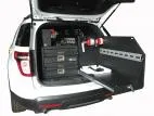 Slide-out tray extended past the rear bumper, slotted mounting panel and extinguisher alongside