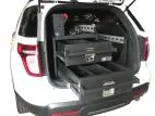 Both drawers pulled fully open at the tailgate of a white Ford utility, divided interiors visible