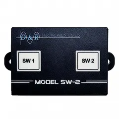 D&R SW-2 dual switch module with backlit SW 1 and SW 2 buttons on a black anti-spill LEXAN front