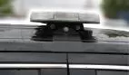 Close-up of a compact bar on its bolted roof bracket, white LEDs visible through the clear lens