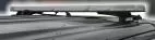 Unlit bar seen from the side on a vehicle roof, showing the low-profile lens and its roof mounting feet