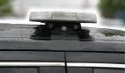 Close-up of a compact bar on its bolted roof bracket, white LEDs visible through the clear lens