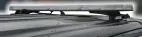 Unlit bar seen from the side on a vehicle roof, showing the low-profile lens and its roof mounting feet