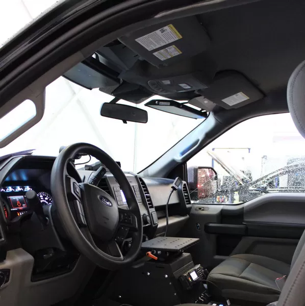Ford F150 cab interior with the slim visor bar fitted along the windshield header beside the sun visors