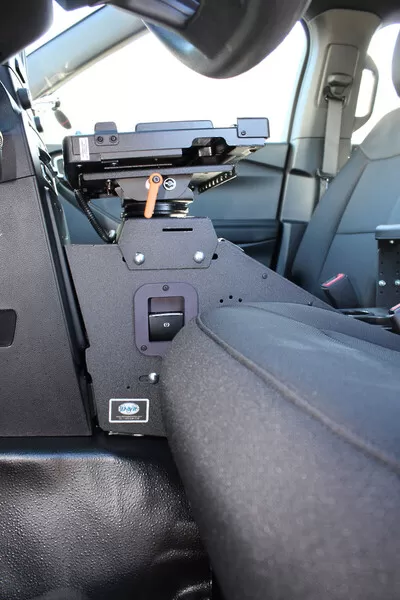 Low angle along the console with the empty dock plate, orange swing-arm lock and D&R badge plate