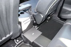 Rear floor tray and back bracket of the console where it bolts to the vehicle floor behind the seats
