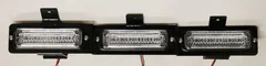 Bare three-module assembly on its black mounting bracket with wiring pigtails, straight-on and unlit