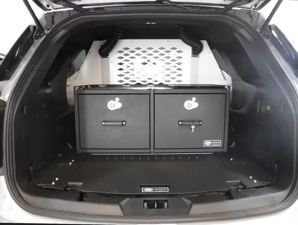 Two black cabinet doors with keyed T-handle locks below the cage, HVAC hoses running up each side