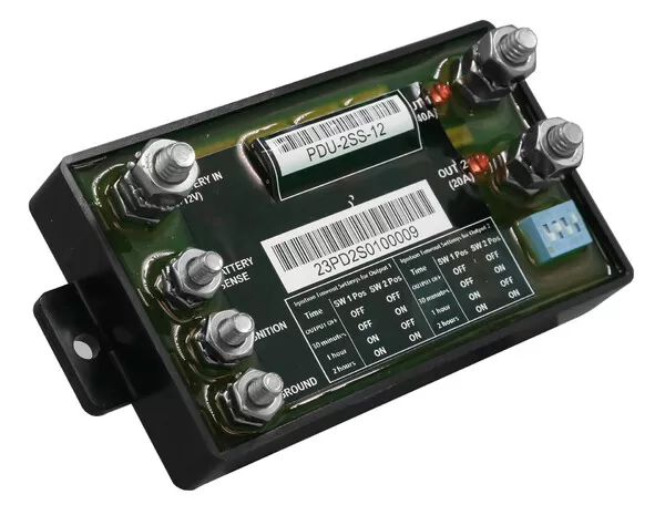 Tilted view showing the four-position DIP switch, side mounting bracket and low-profile black housing