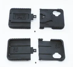 All four molded parts and two mounting screws laid out flat, dock face above, phone cavity below