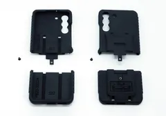 All four moulded parts and the two assembly screws laid out on white before assembly